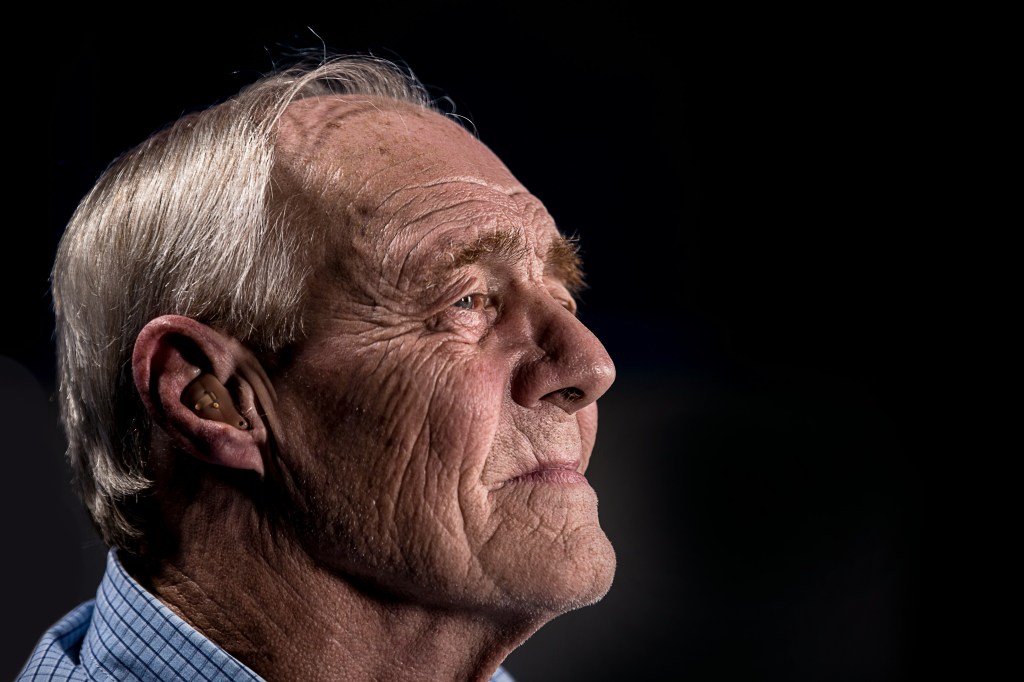 an elderly man looking reflective